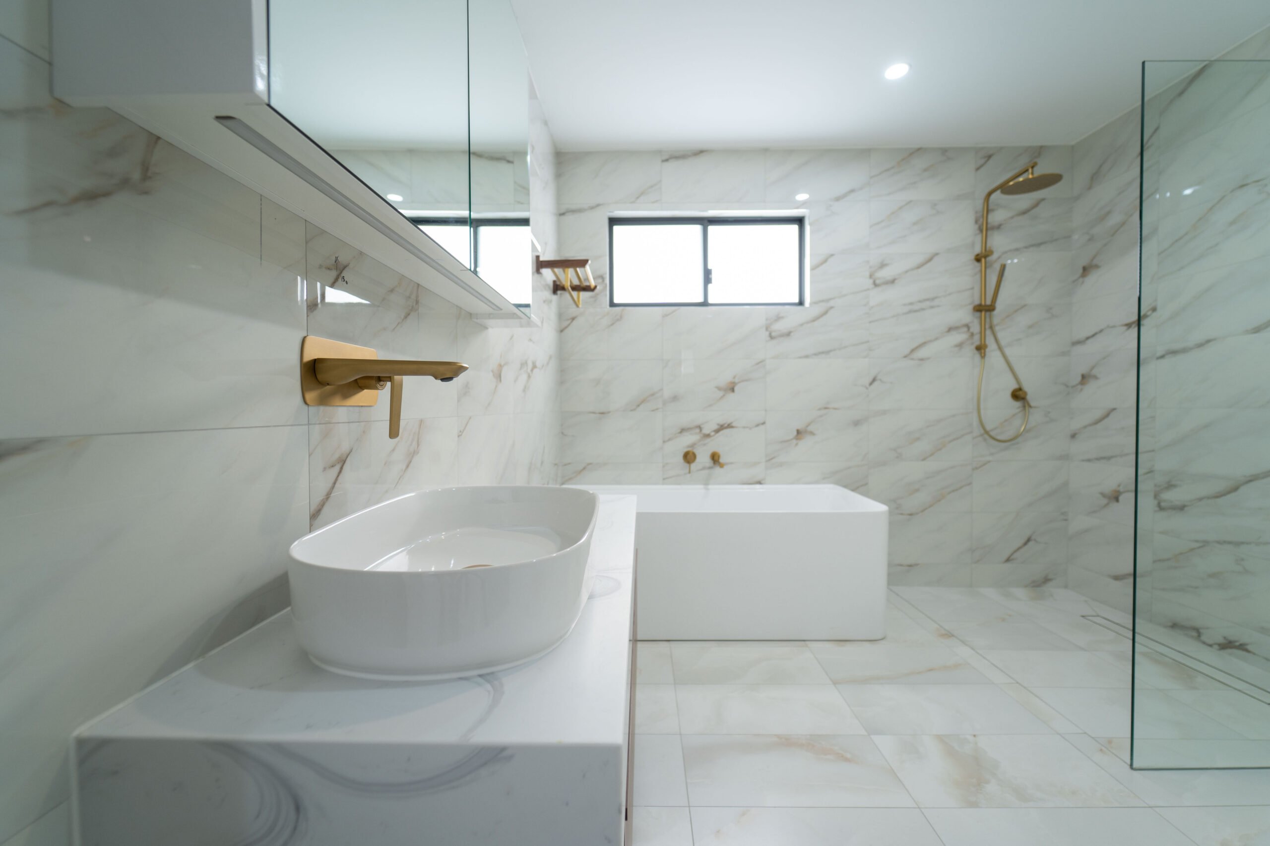 Stone bathroom vanity and custom joinery detail by Renolux