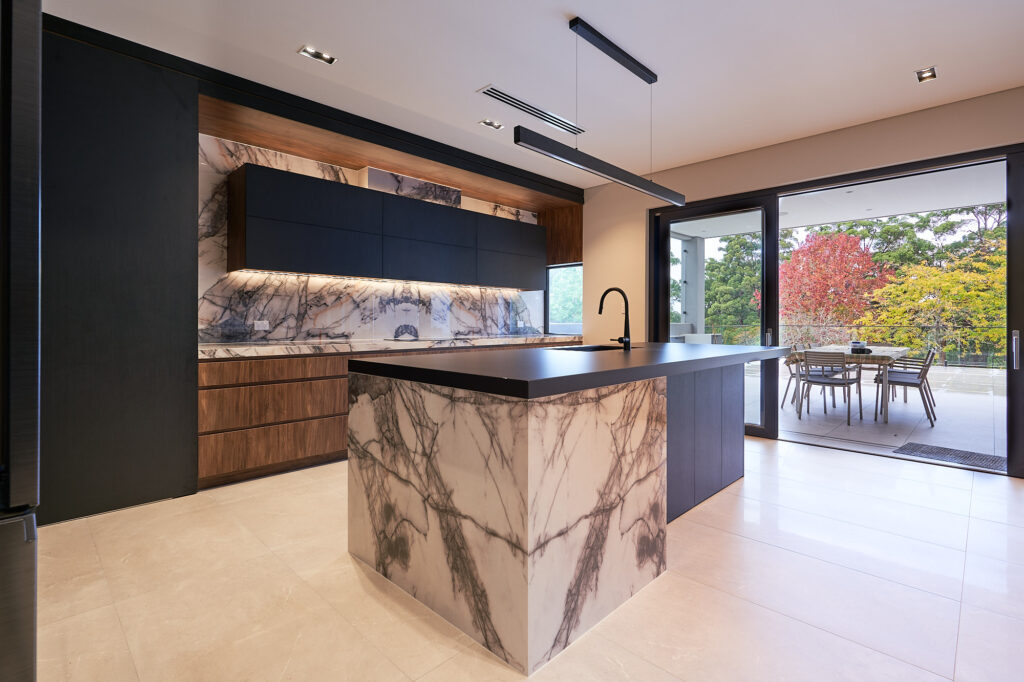Flat black and timber custom kitchen island designed by Renolux