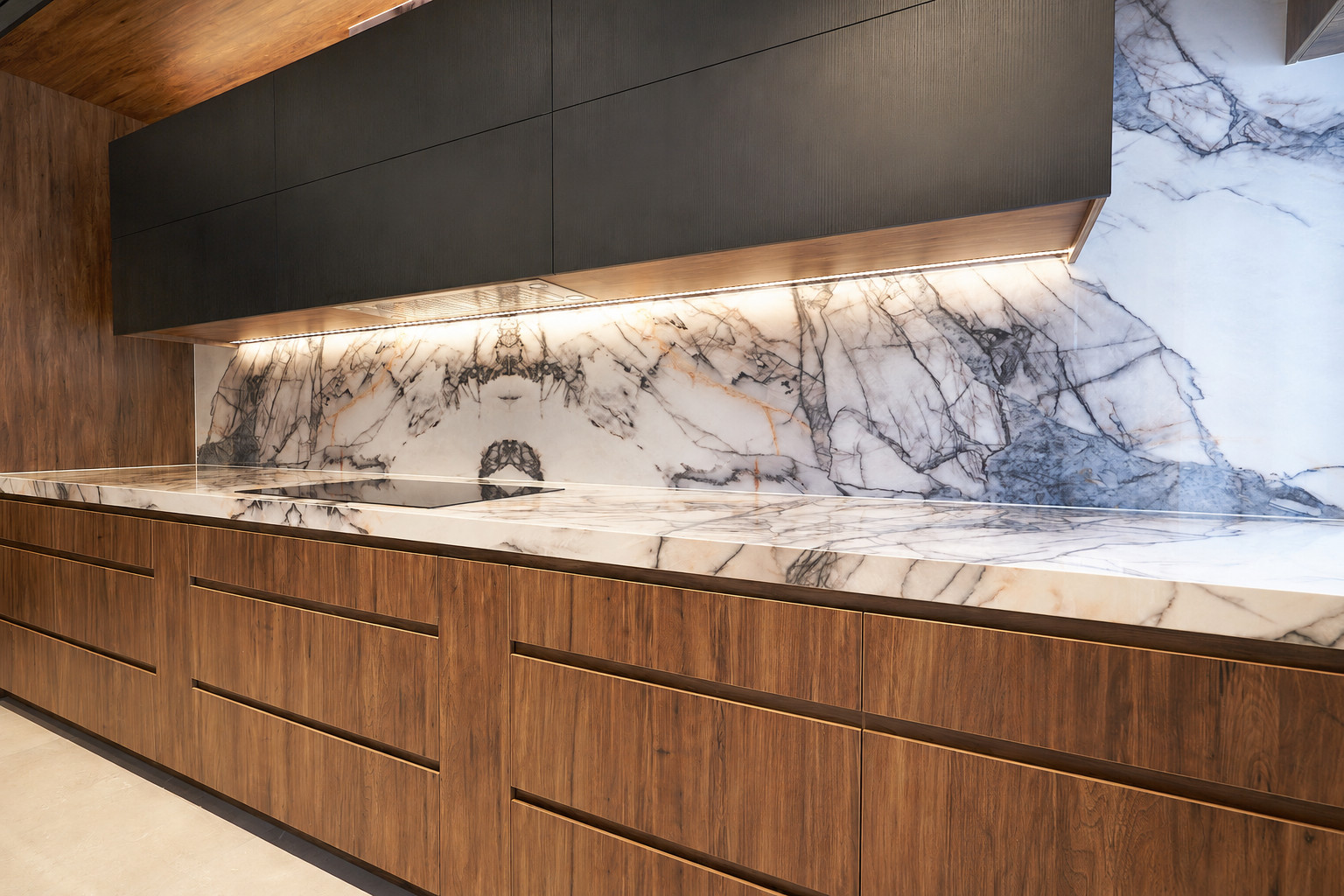 Custom black and timber kitchen joinery with stone countertop by Renolux Sydney