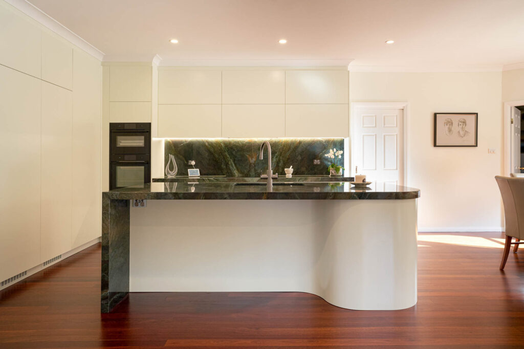 Flat white custom kitchen island with green stone by Renolux Sydney