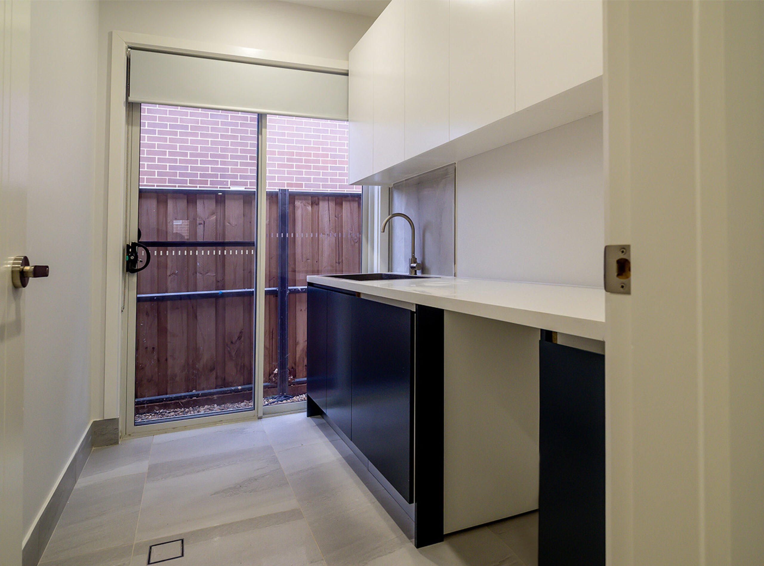 Dark blue custom laundry joinery by Renolux Sydney
