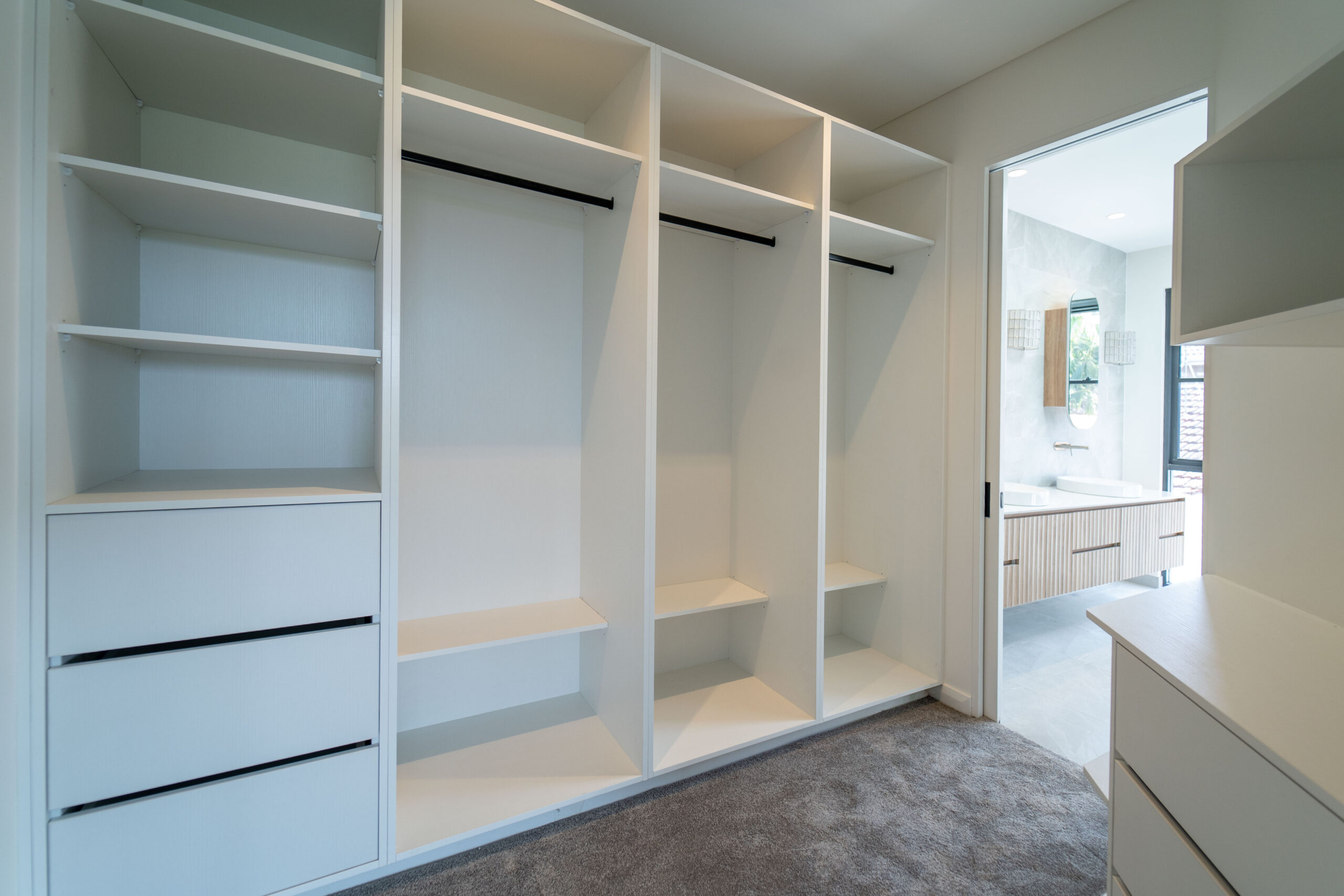 White custom wardrobe drawers and cabinetry detail