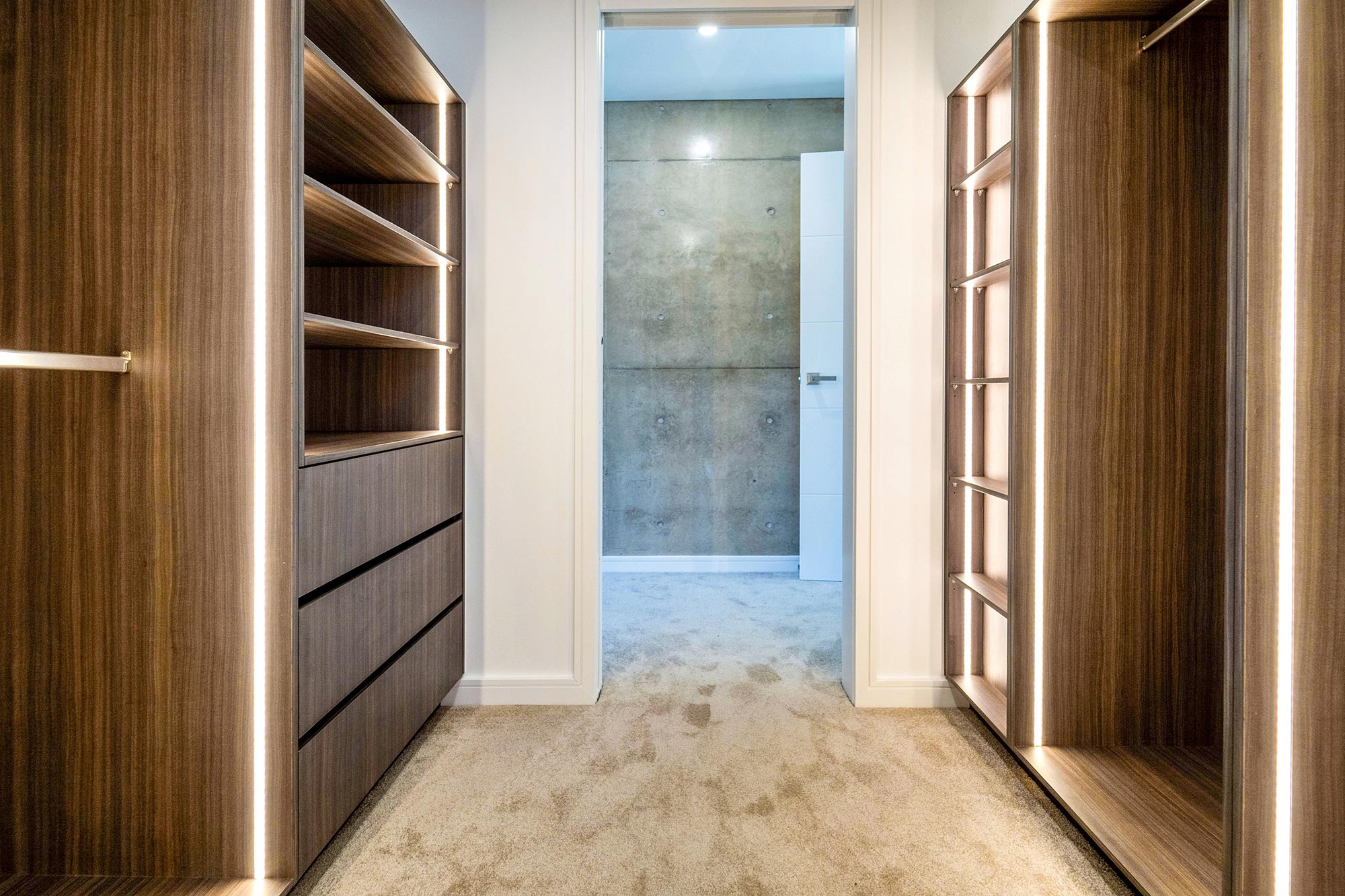 Walk-in wardrobe with integrated lighting by Renolux Sydney